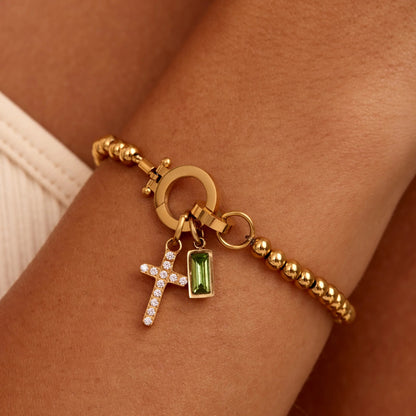 Pulsera con dije de cruz y piedra natal de cuentas