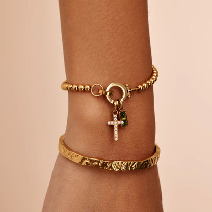 Pulsera con dije de cruz y piedra natal de cuentas